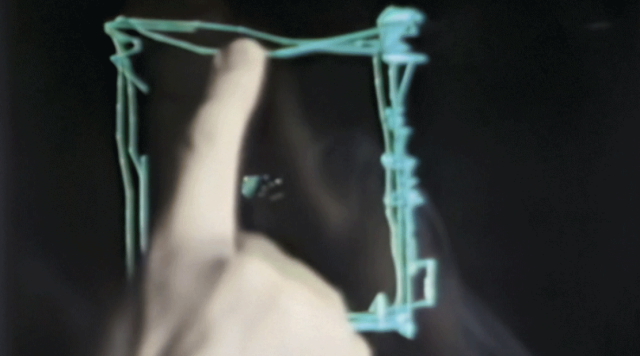 A hand draws on an early touch sensitive screen.